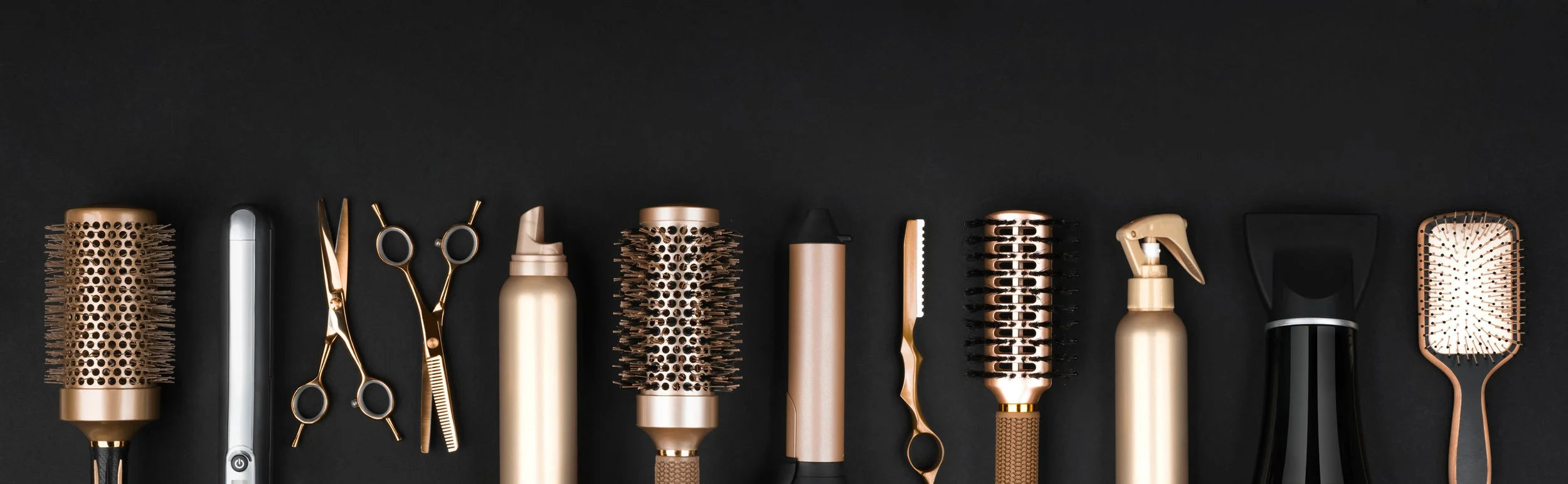 Collection of hairdressing tools on a black background